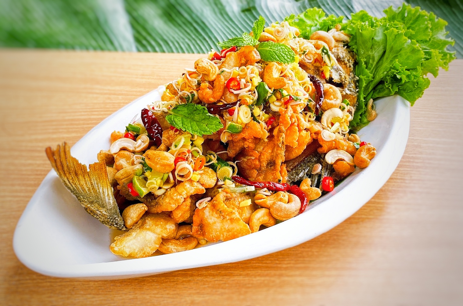 ปลากระพงสมุนรไพร ( Deep Fried Sea Bass with Mix Herb Sauce )